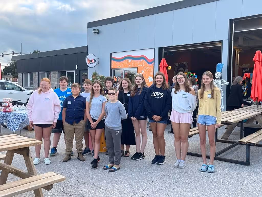 Young entrepreneurs gathered for a group photo at a youth market.