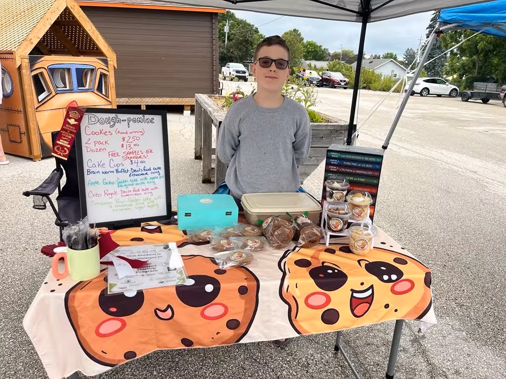 Dough-pamine baked goods and price list at a youth market.