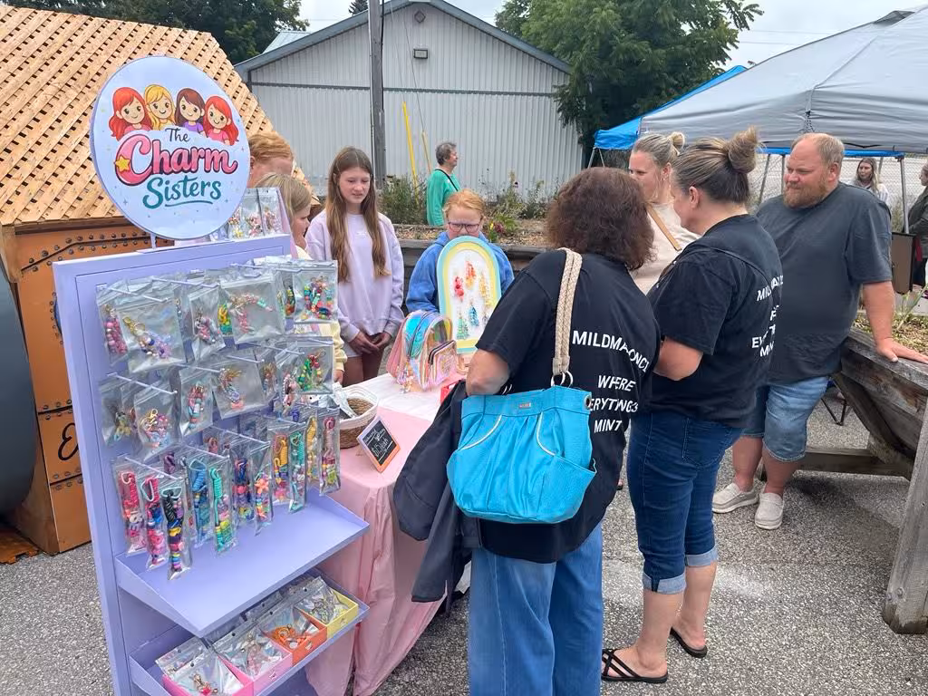 The Charm Sisters craft display at a youth market.