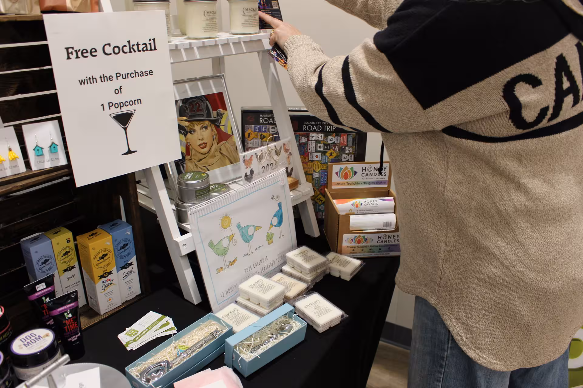 Cocktail, popcorn, and artisan products at a WOWSA vendor display.