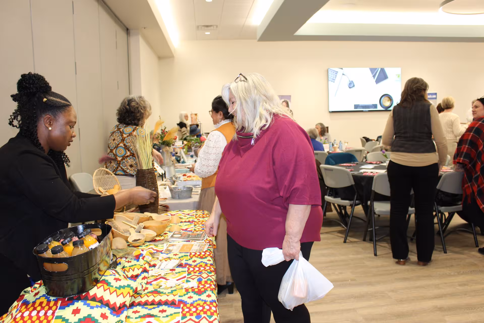 WOWSA attendee speaking with a vendor at a display table.