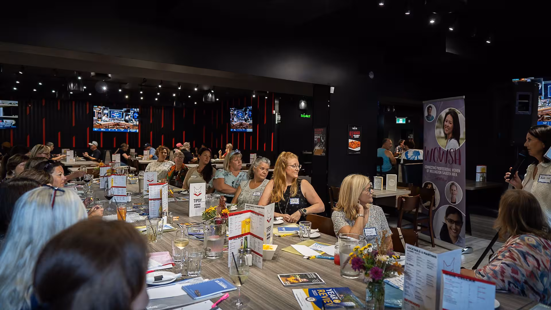 Women meeting at vendor tables during a WOWSA event.
